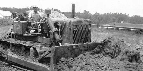 A black and white photo of an old tractor.