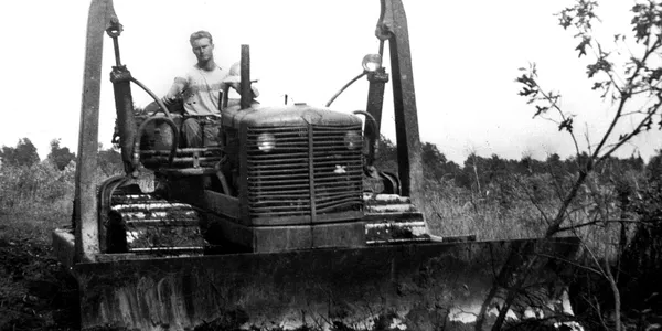 A man sitting on top of a tractor.