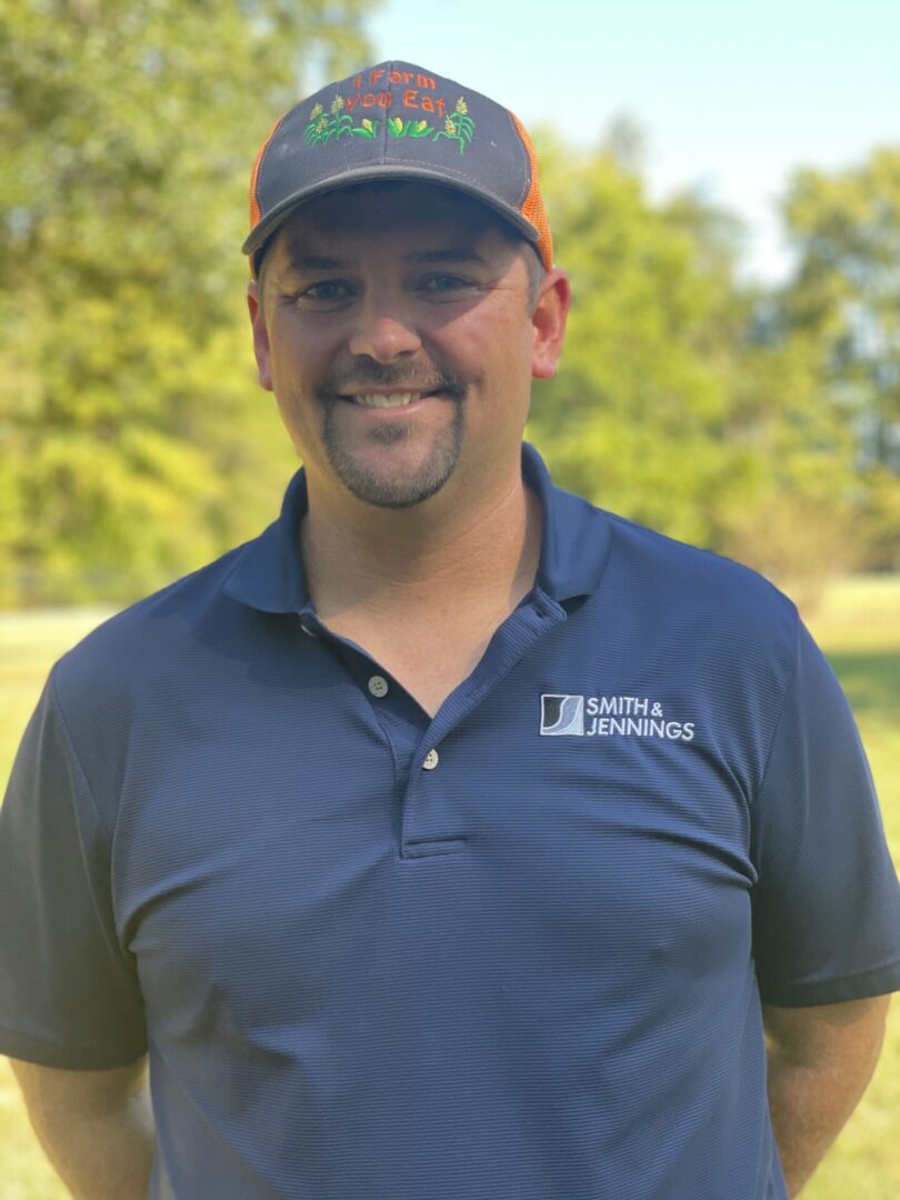 A man in blue shirt wearing an orange hat.